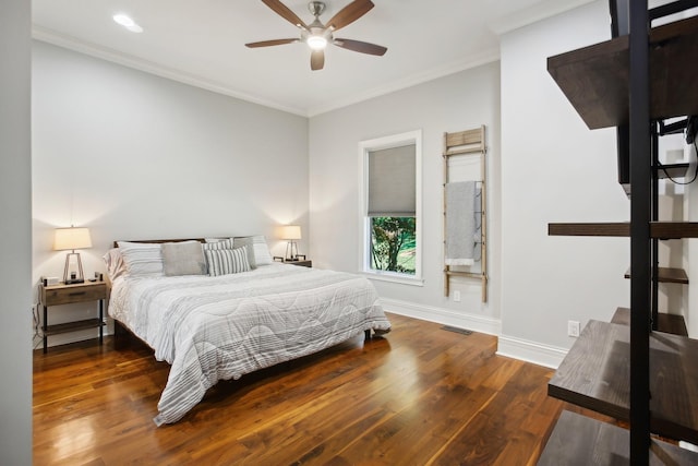 bedroom with ornamental molding, visible vents, and wood finished floors