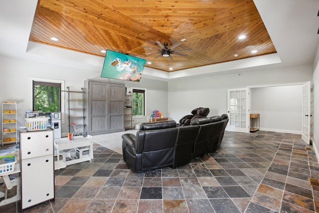 living room with wood ceiling, a tray ceiling, baseboards, and recessed lighting