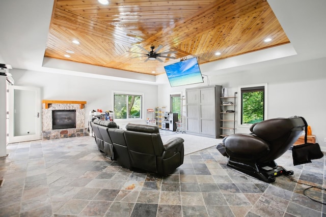 living area with a tray ceiling, wooden ceiling, and recessed lighting