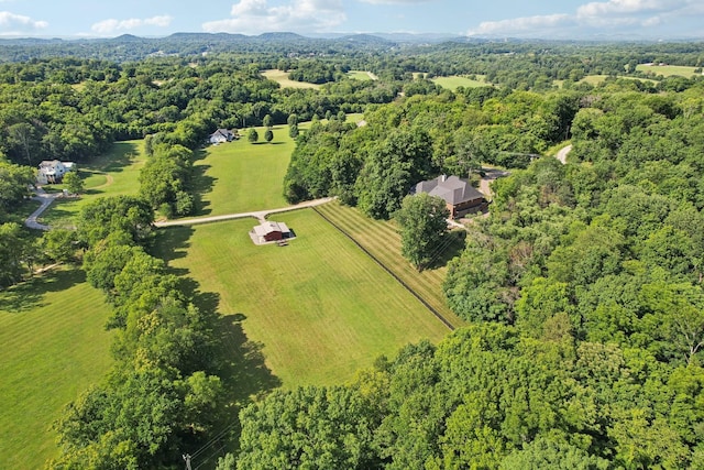 drone / aerial view featuring a wooded view