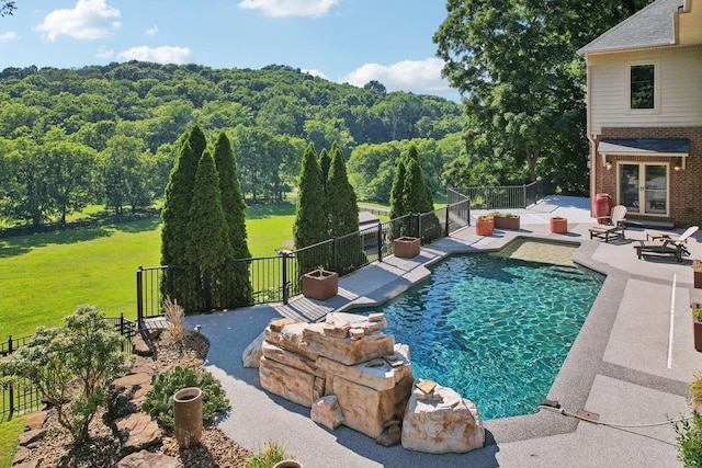 view of swimming pool featuring a fenced in pool, a patio area, fence, and a lawn