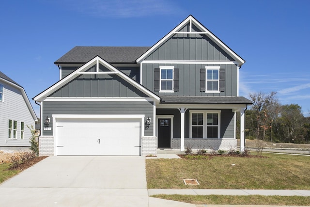 craftsman house featuring concrete driveway, brick siding, board and batten siding, and a front lawn