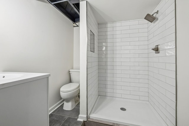 full bath with toilet, vanity, tile patterned flooring, tiled shower, and baseboards