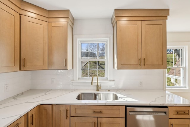 kitchen with decorative backsplash, dishwasher, light stone counters, and a sink