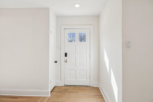 entryway featuring light wood-type flooring and baseboards