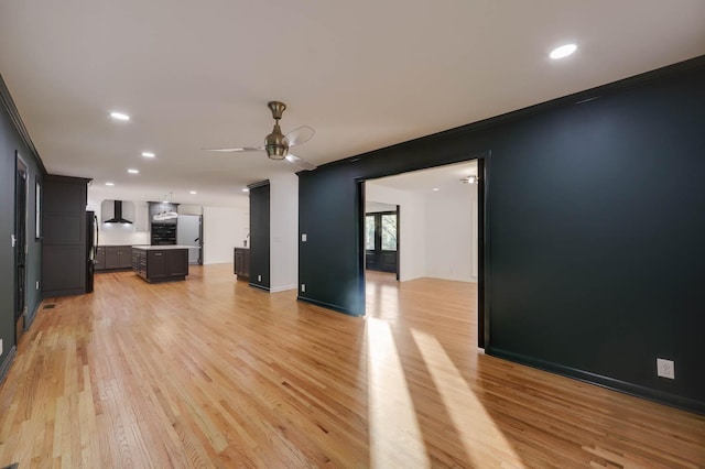 unfurnished living room featuring light wood-style flooring, baseboards, a ceiling fan, and recessed lighting