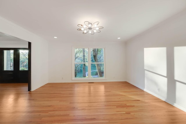 spare room featuring light wood-style floors, recessed lighting, and baseboards