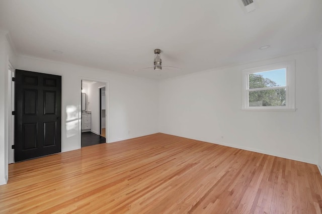 unfurnished room featuring a ceiling fan, visible vents, and wood finished floors