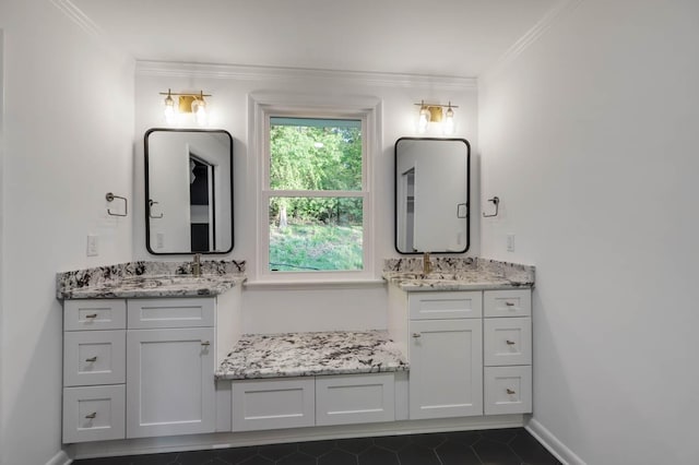 full bathroom with baseboards, a sink, two vanities, and crown molding