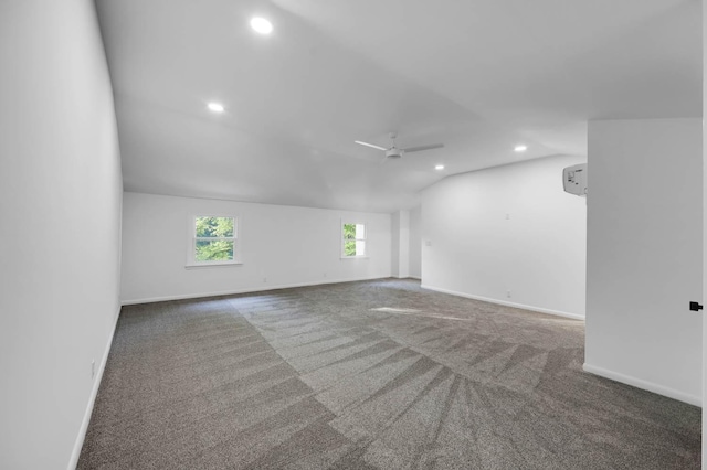 unfurnished room featuring ceiling fan, baseboards, vaulted ceiling, and carpet flooring