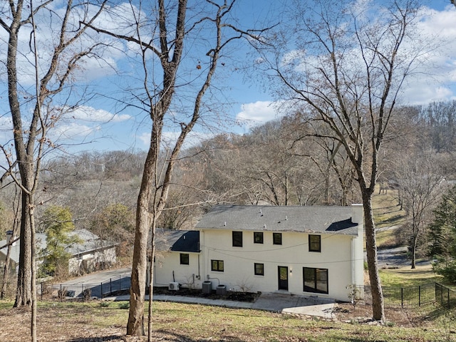 rear view of property with central AC, a patio area, and fence