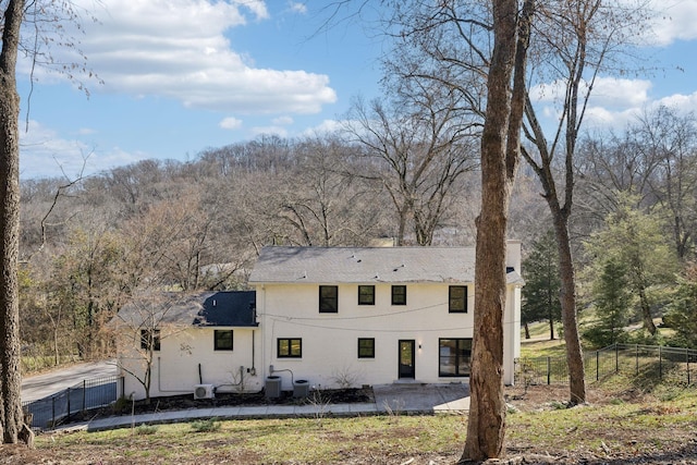 rear view of property with a patio, fence, and central air condition unit