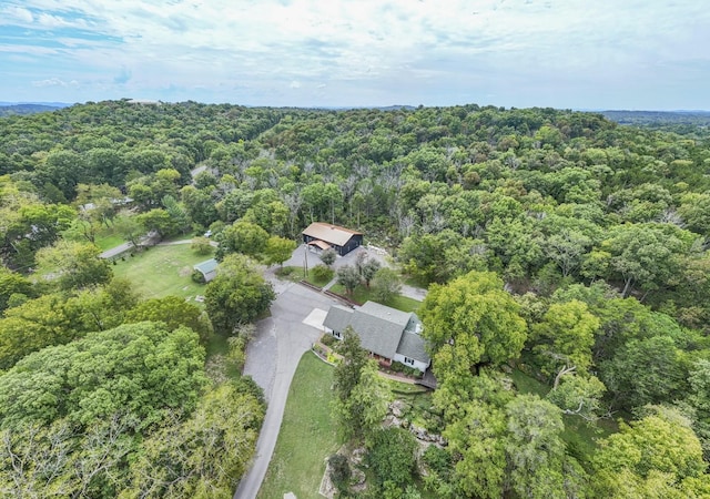 birds eye view of property featuring a view of trees