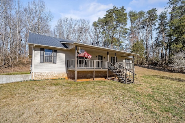 single story home with stairs, metal roof, a front lawn, and a porch