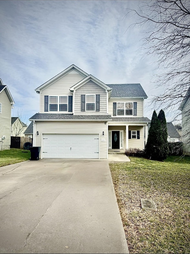 traditional home featuring an attached garage, fence, a front lawn, and concrete driveway