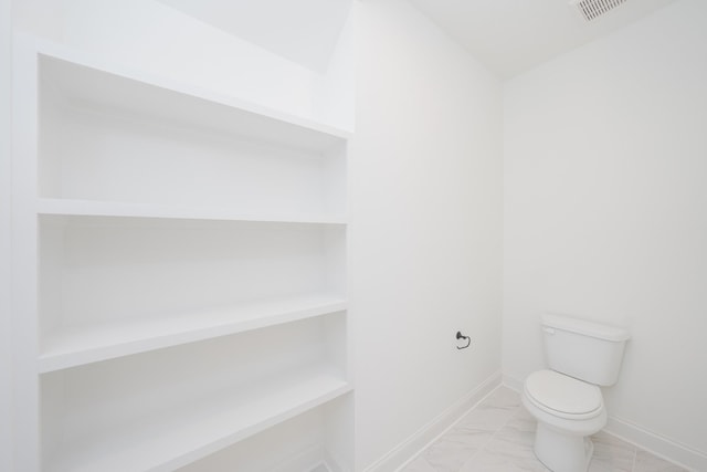 bathroom with visible vents, marble finish floor, toilet, and baseboards