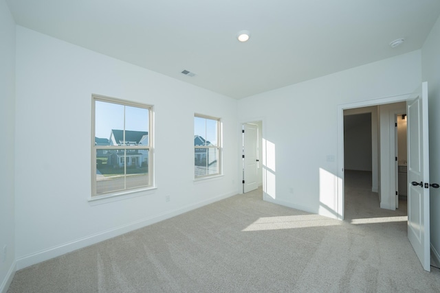 unfurnished bedroom featuring carpet floors, visible vents, and baseboards