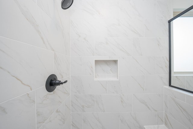 interior details featuring tiled shower