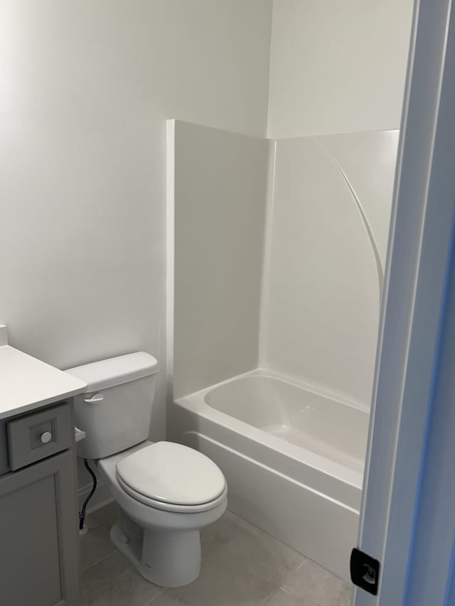 bathroom with vanity, toilet, and tile patterned floors