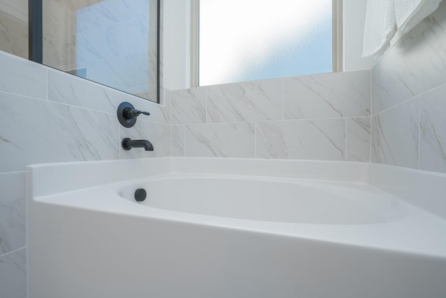 full bathroom with tile walls and a tub