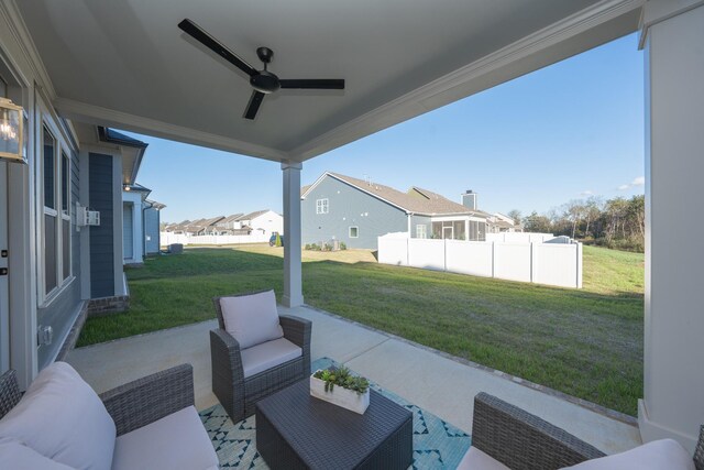 view of patio / terrace featuring an outdoor living space, fence, a residential view, and a ceiling fan