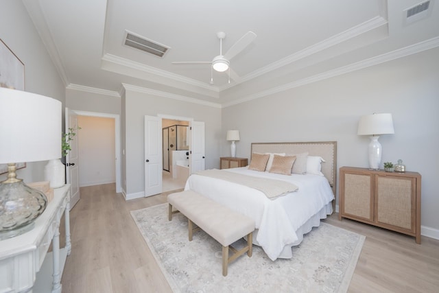 bedroom featuring ornamental molding, light wood-type flooring, and visible vents