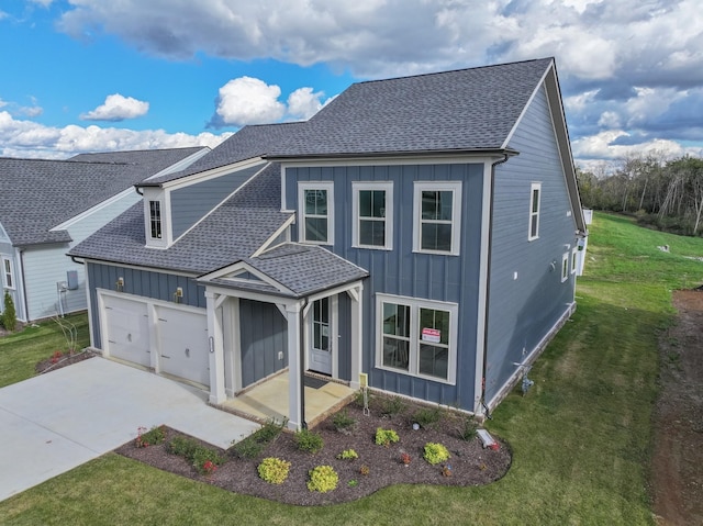 view of front facade with a garage, a shingled roof, concrete driveway, board and batten siding, and a front yard