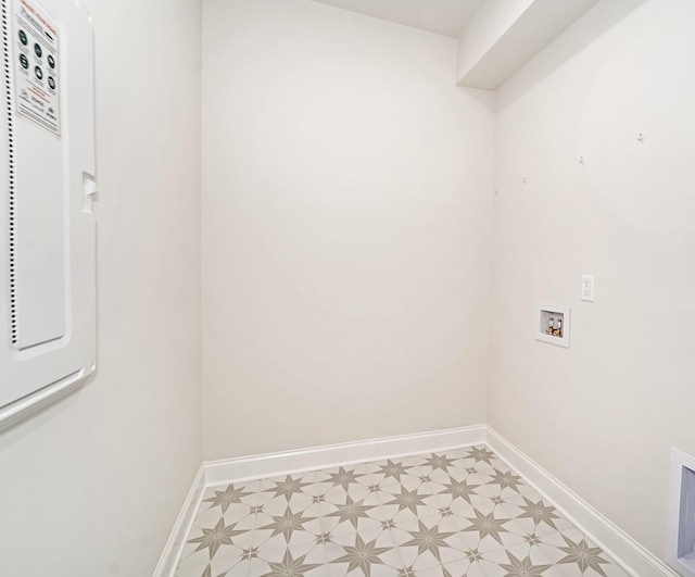 laundry area with laundry area, baseboards, washer hookup, and light floors