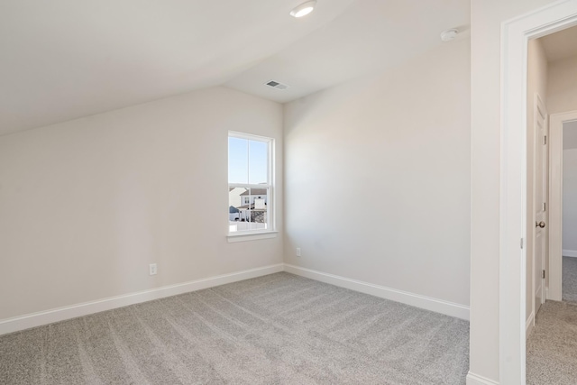 additional living space featuring lofted ceiling, baseboards, visible vents, and light colored carpet