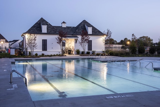 community pool featuring a patio area and fence