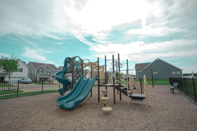 community play area with a residential view and fence