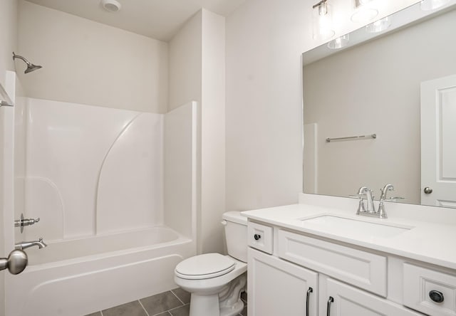 full bathroom featuring washtub / shower combination, vanity, toilet, and tile patterned floors