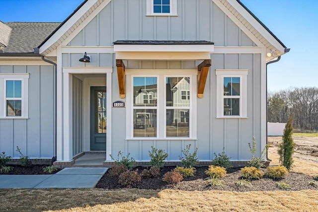 view of front facade featuring roof with shingles and board and batten siding