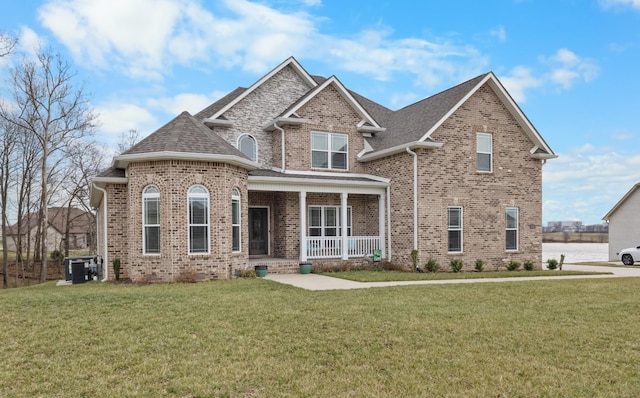 view of front of house featuring covered porch, brick siding, and central air condition unit