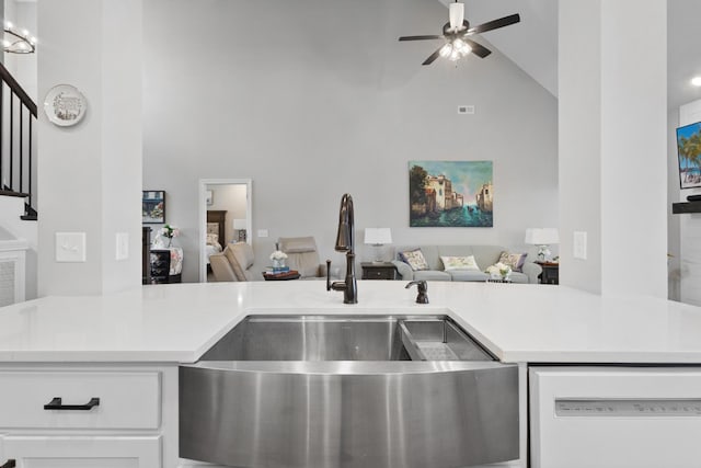 kitchen with open floor plan, light countertops, white dishwasher, and a sink