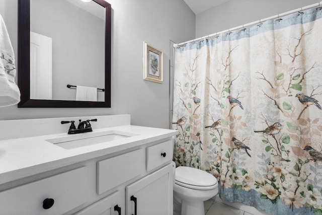 bathroom featuring toilet, a shower with shower curtain, and vanity