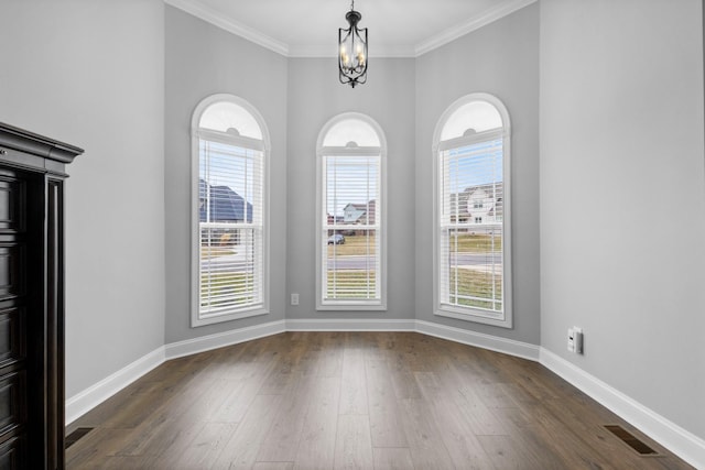 unfurnished dining area with a chandelier, visible vents, dark wood finished floors, and baseboards