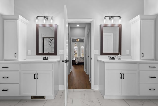 bathroom with connected bathroom, two vanities, visible vents, marble finish floor, and a shower