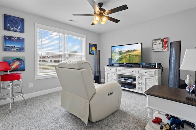 living area featuring ceiling fan, carpet, visible vents, and baseboards