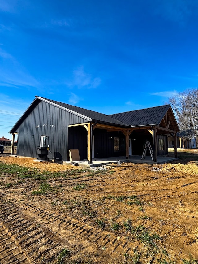 back of property with board and batten siding and cooling unit