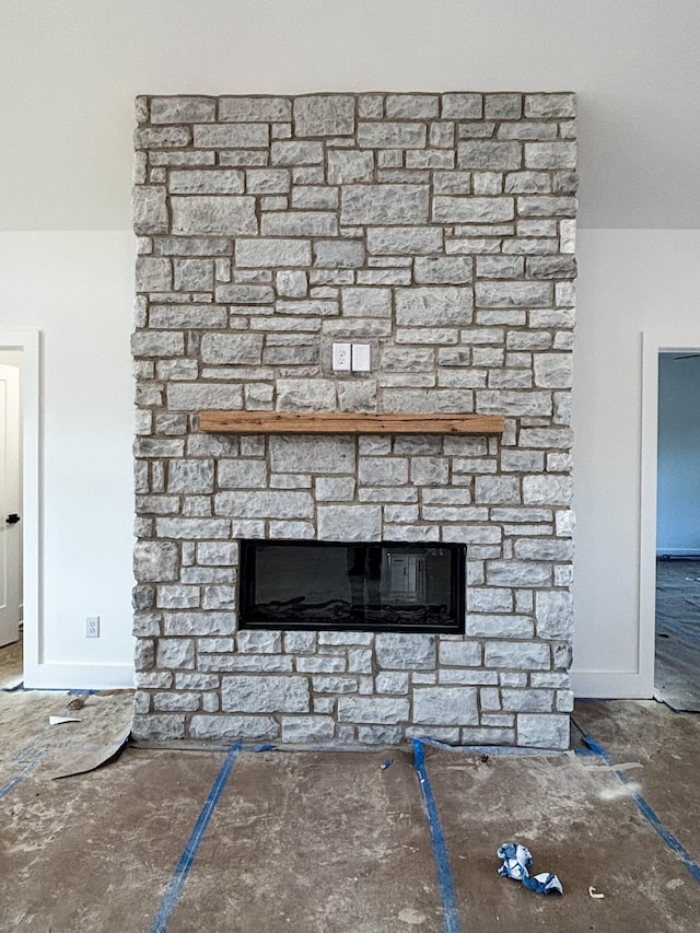 details featuring a fireplace and baseboards