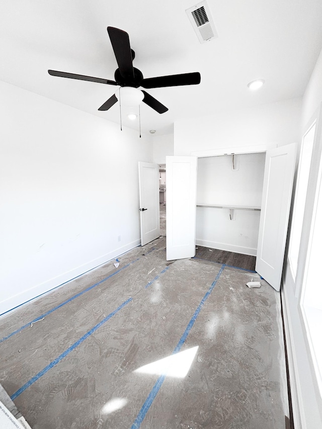 unfurnished bedroom with baseboards, visible vents, ceiling fan, and a closet