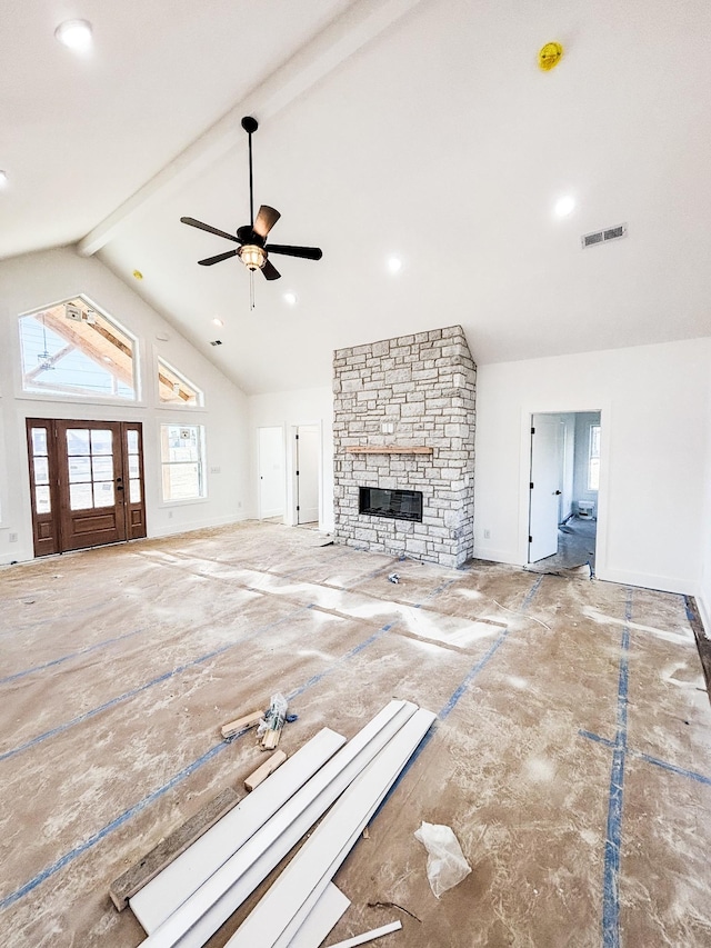 unfurnished living room with a fireplace, visible vents, ceiling fan, high vaulted ceiling, and beamed ceiling