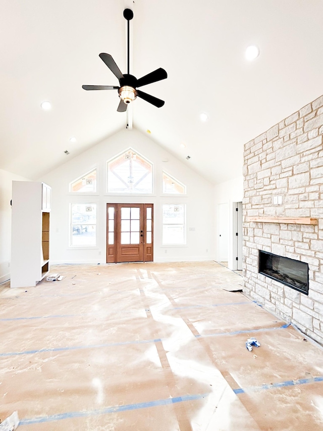 unfurnished living room featuring ceiling fan, high vaulted ceiling, recessed lighting, a fireplace, and baseboards