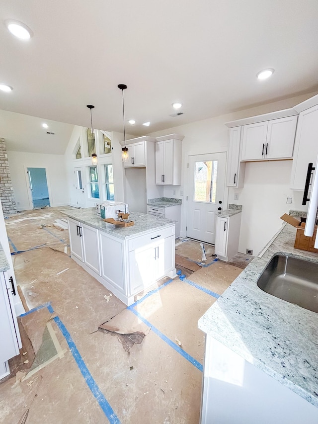 kitchen with recessed lighting, a center island, decorative light fixtures, and white cabinets