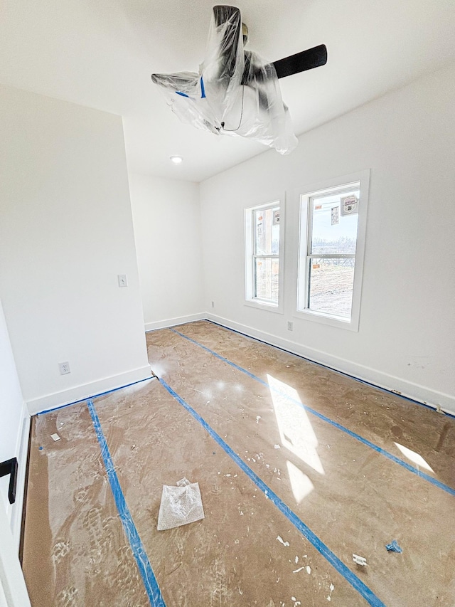 unfurnished room with baseboards