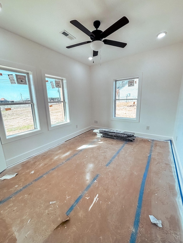 empty room with plenty of natural light, visible vents, and baseboards