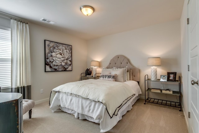 bedroom with light colored carpet, visible vents, and baseboards