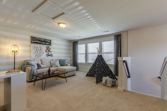 living room featuring visible vents, attic access, and light colored carpet