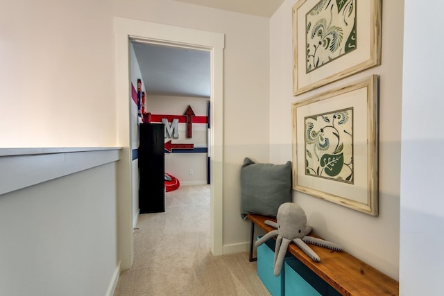 corridor featuring baseboards and light colored carpet